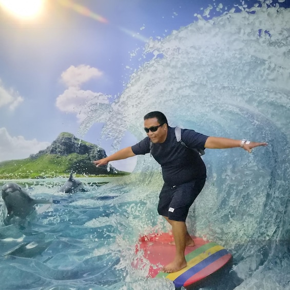 A person surfing on a colorful board in the ocean with dolphins nearby and a mountain in the background. 4