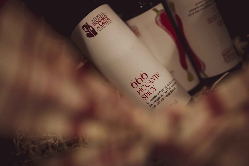 A bottle of 666 Piccante Spicy condiment with a label featuring a chili pepper. 4