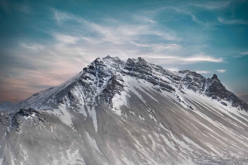 A snow-covered mountain peak with a clear sky. 3