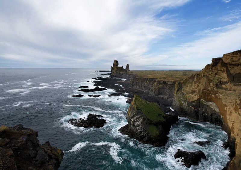A rugged coastline with rocky cliffs and turbulent ocean waves. 5