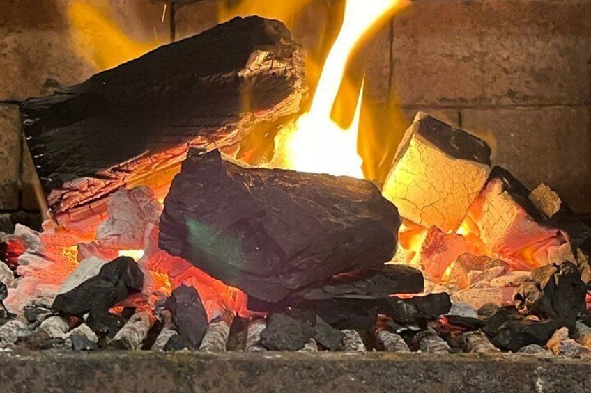 A fire with glowing embers and flames. 4
