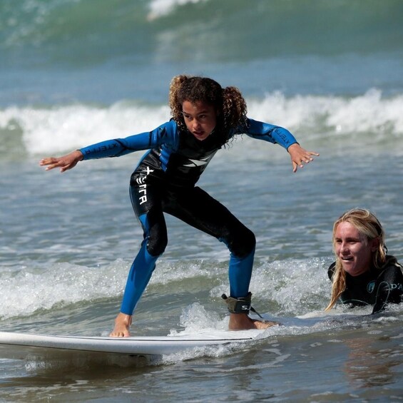 A person surfing on a wave with a wetsuit. 4