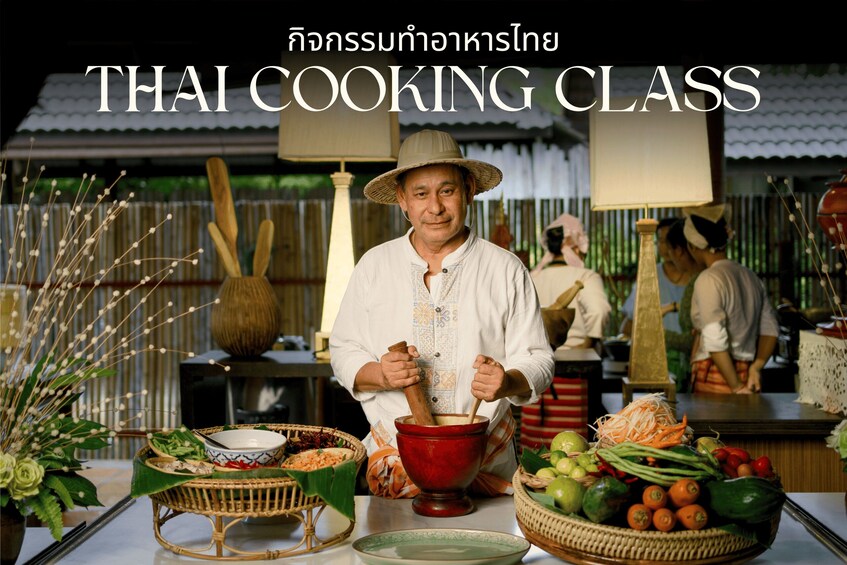 A person in traditional Thai attire holding a wooden pestle, surrounded by various cooking ingredients and utensils. 1