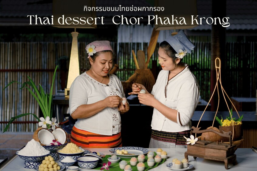 Two individuals preparing Thai dessert Chor Phaka Krong, surrounded by traditional Thai ingredients and utensils. 2