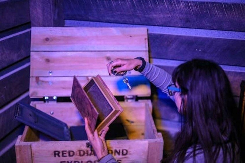 A person opening a wooden crate with the words 'RED DIAMOND EXPLOSIONS' on it. 4