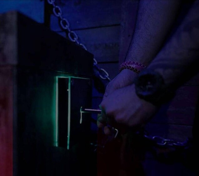 A person unlocking a door with a key. 5