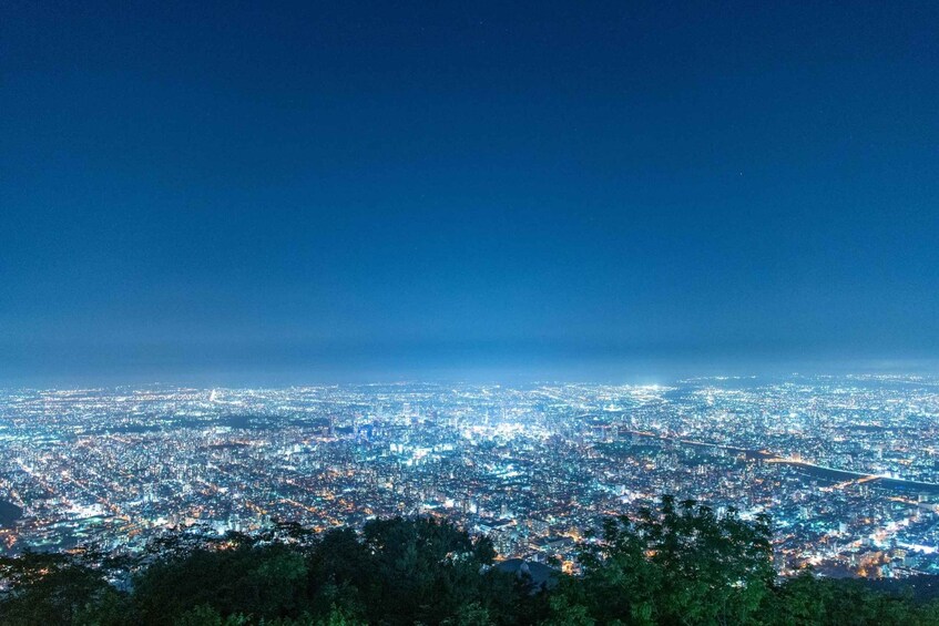 A nighttime cityscape with dense urban lighting. 3