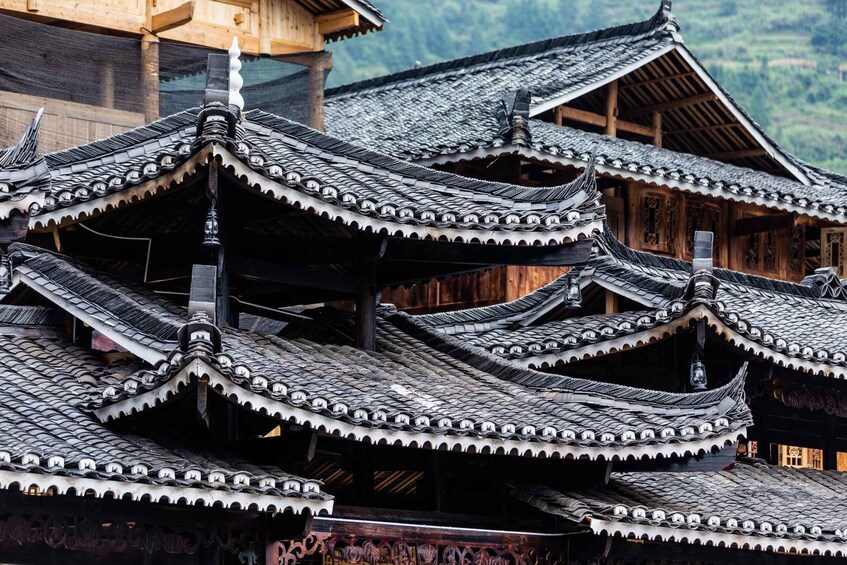 Traditional multi-tiered roofs with ornate eaves and wooden structures. 2