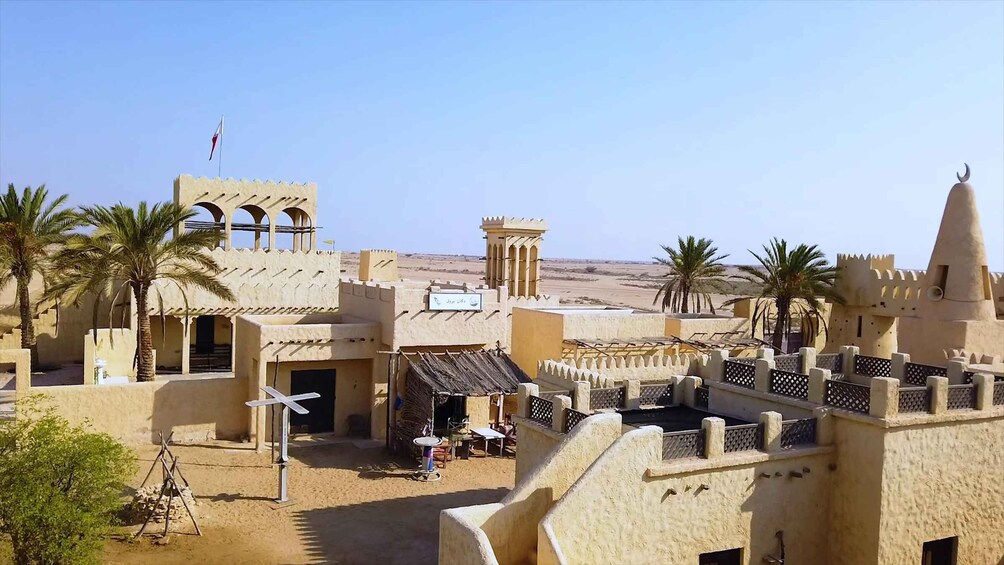 A desert-themed architectural model with palm trees and a clear sky. 2