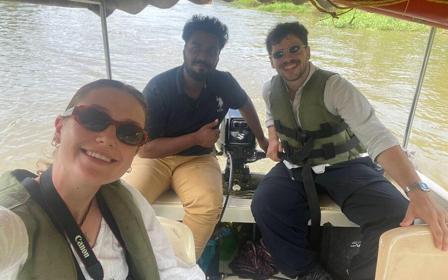 Three people on a boat with water in the background. 5