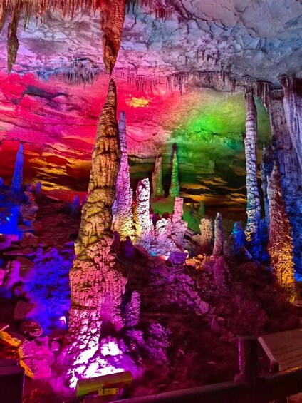A colorful cave with stalactites and stalagmites. 4