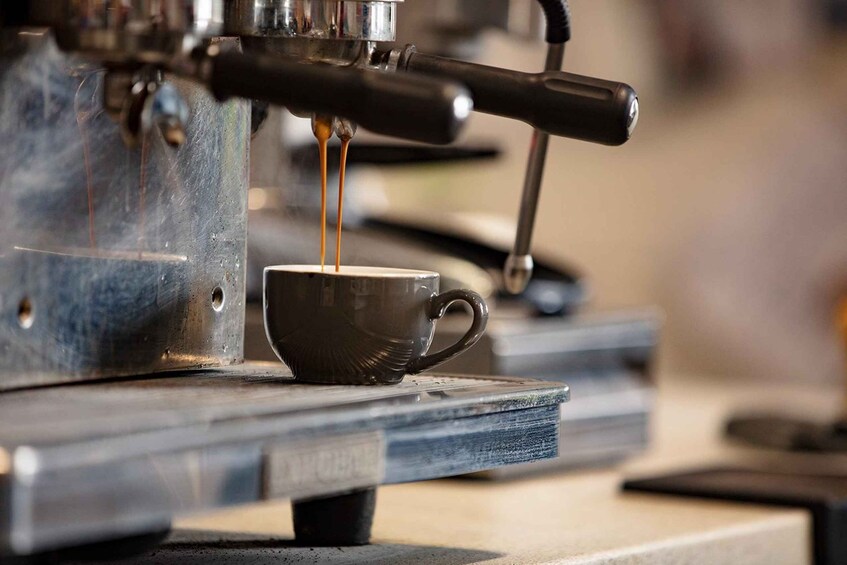 A coffee machine dispensing espresso into a cup. 2