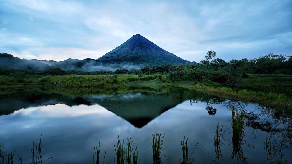 A mountain with a lake in the foreground reflecting the mountain and sky. 2