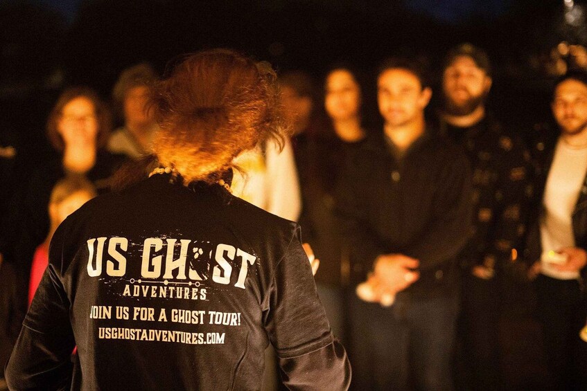 A person wearing a jacket with 'US GHOST ADVENTURES' and a website address. 4