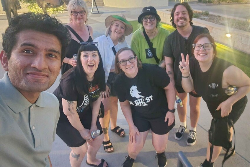 A group of people posing for a photo outdoors. 3