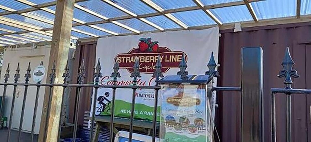 A covered area with a sign reading 'Strawberry Line Cycle,' a bicycle rental service. 2