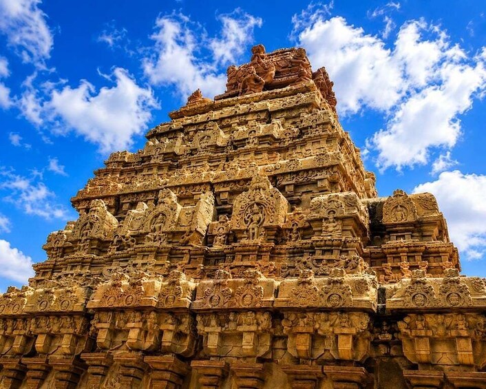 A detailed stone temple with intricate carvings and a clear blue sky. 4