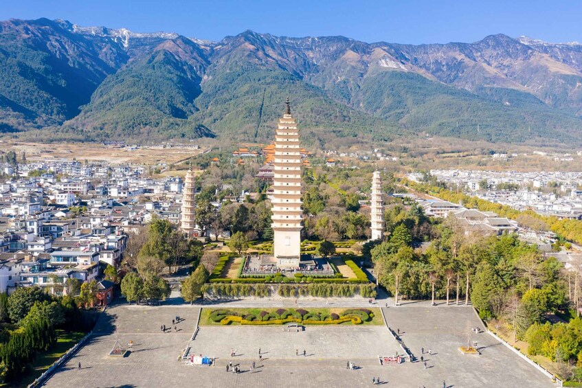 A pagoda surrounded by a town and mountains. 5