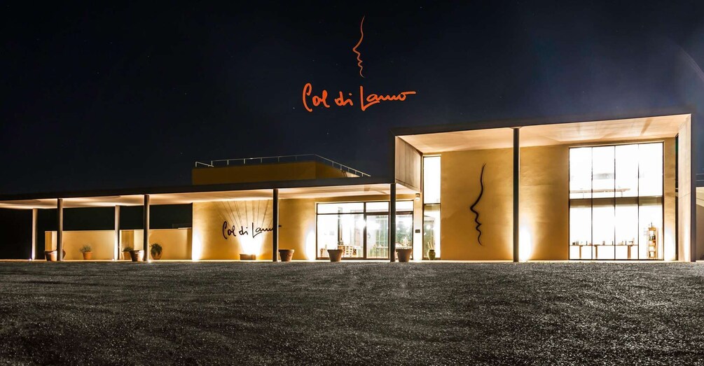 A modern building with illuminated signage at night. 1