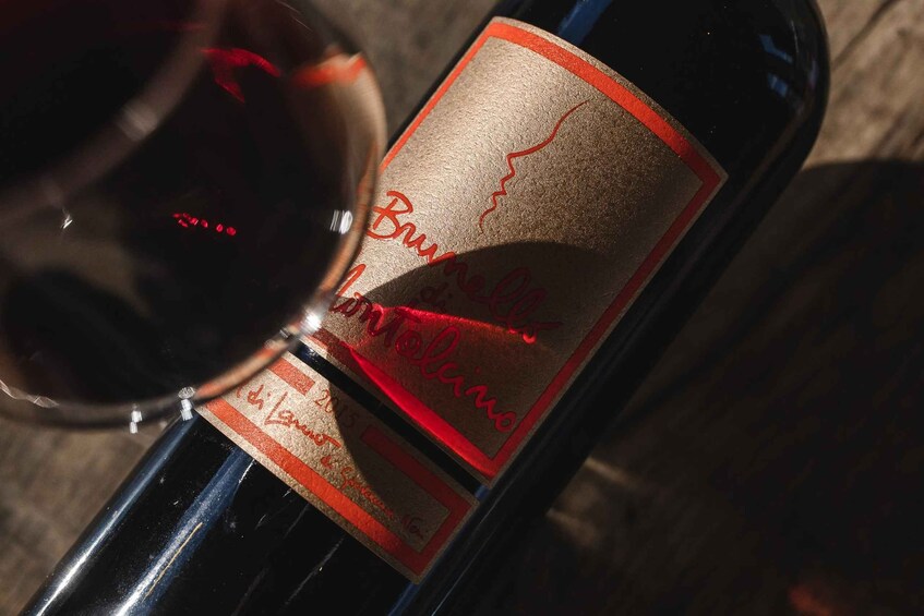 A bottle of wine with a label featuring a red and gold design and the text 'Bordeaux 2015'. 4
