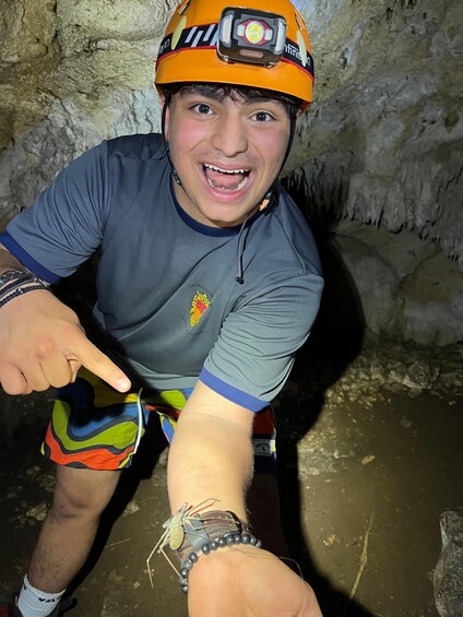 A person wearing a helmet and pointing at something. 2