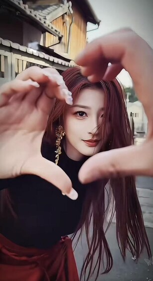 A person making a heart shape with their hands. 1