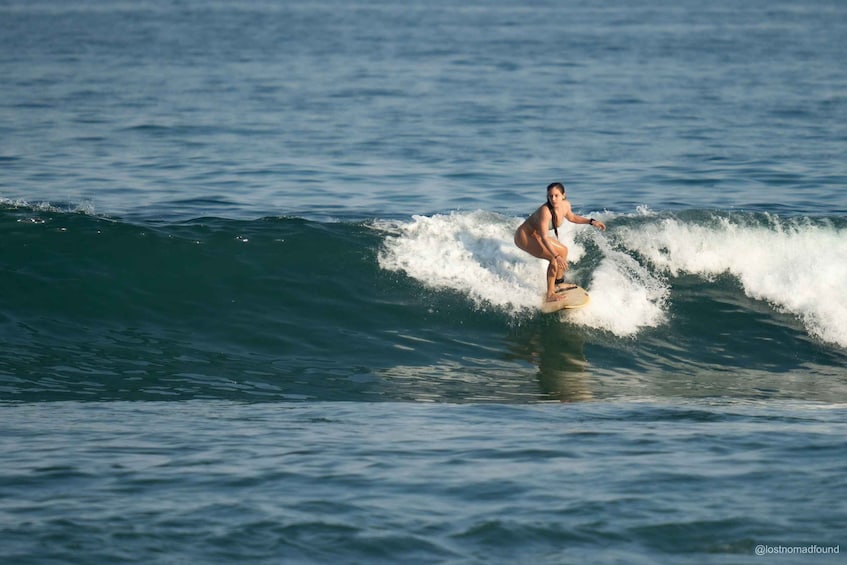 A person surfing a wave in the ocean. 1
