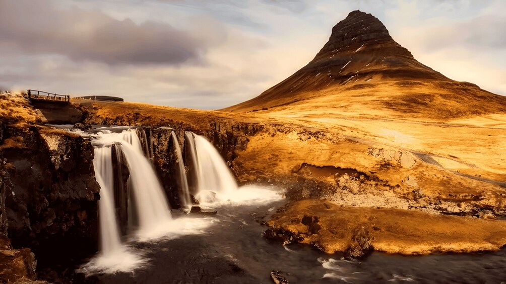 A waterfall, a bridge, and a mountain. 1