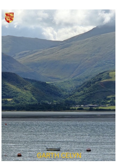 A mountainous landscape with a body of water in the foreground. 1