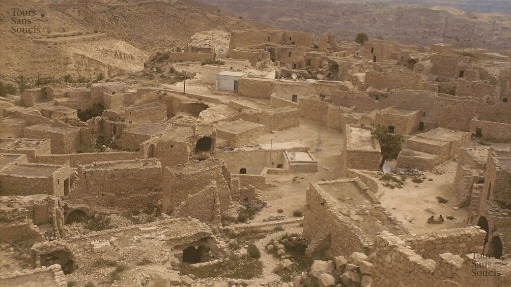 An ancient, sprawling archaeological site with multiple ruins and pathways. 5