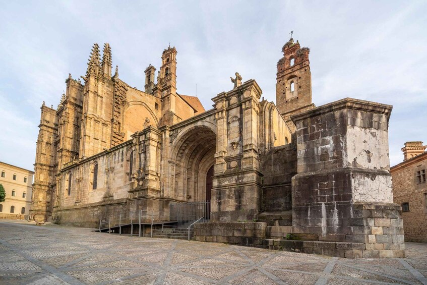 A historic cathedral with intricate architecture, including a large arched entrance and multiple towers. 1