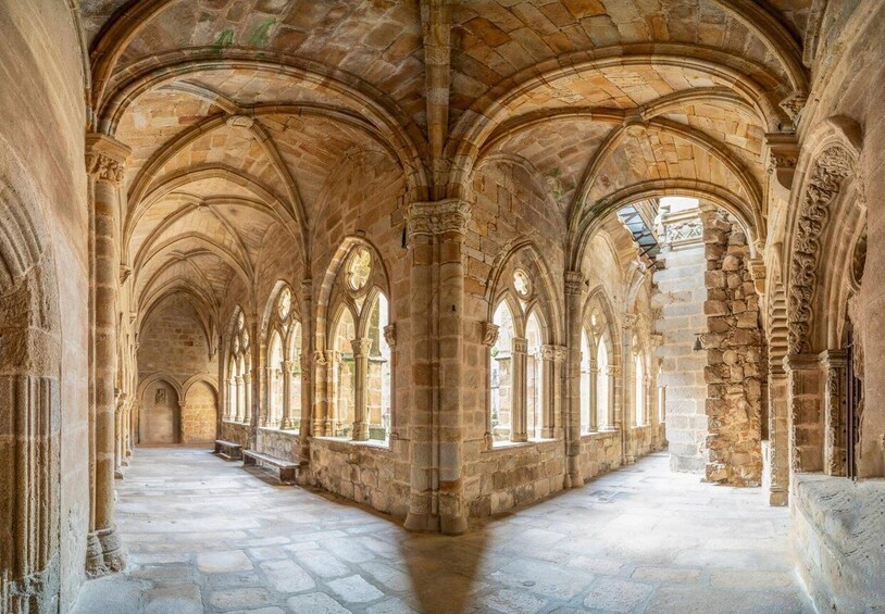 A cathedral interior with arched ceilings and stone columns. 2
