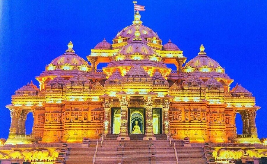 A brightly lit temple with multiple domes and intricate carvings. 3