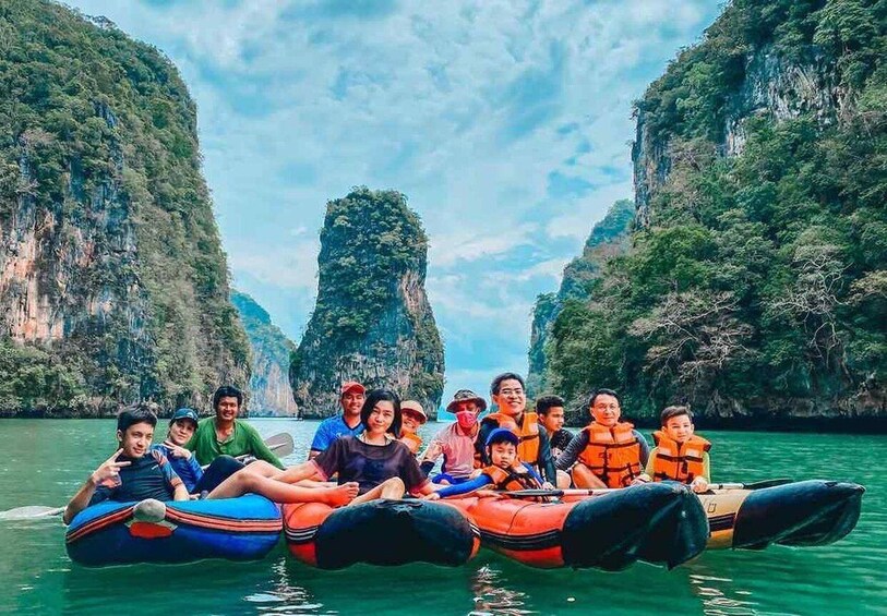 A group of people on a raft in a canyon with steep cliffs. 1