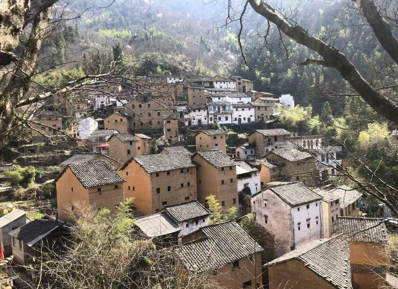 A village with traditional buildings nestled in a mountainous area. 3