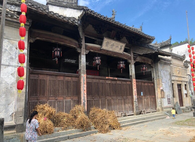 A traditional Chinese building with wooden doors and red lanterns. 2
