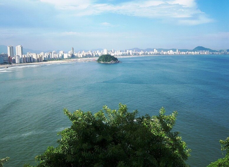 A coastal cityscape with a prominent island in the middle of the water. 2