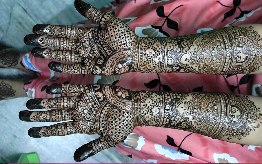 A hand with intricate henna designs. 3