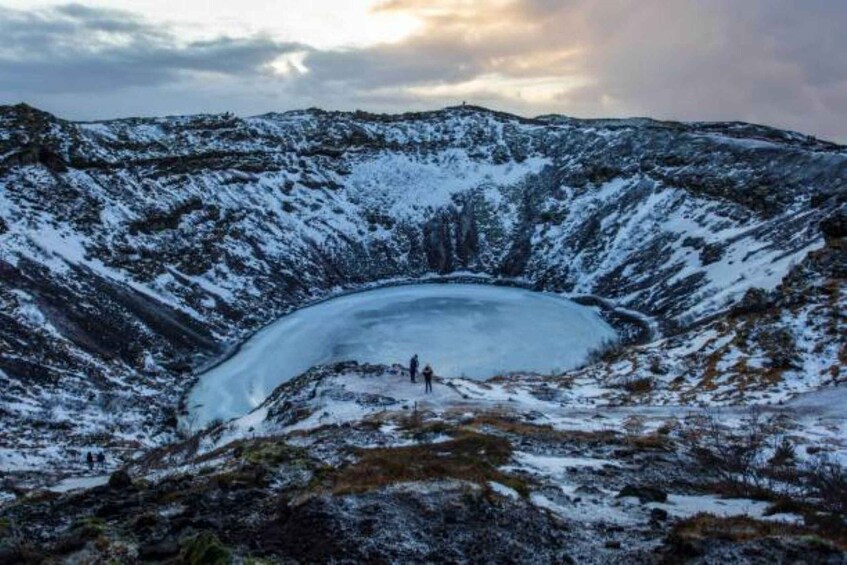 A snow-covered crater lake surrounded by mountains. 4