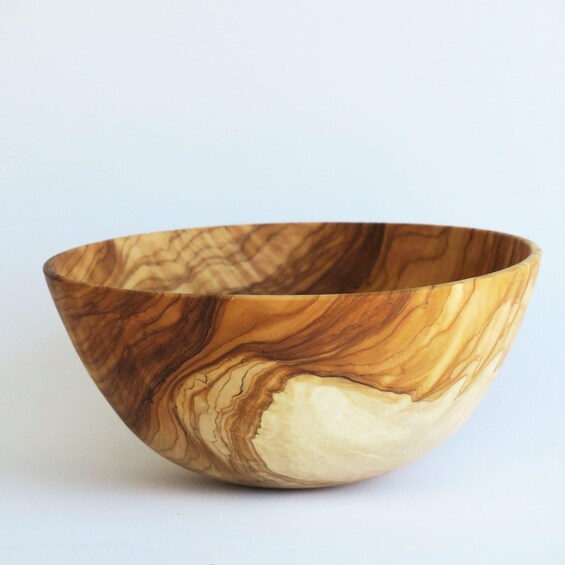A wooden bowl with a natural wood grain pattern. 4