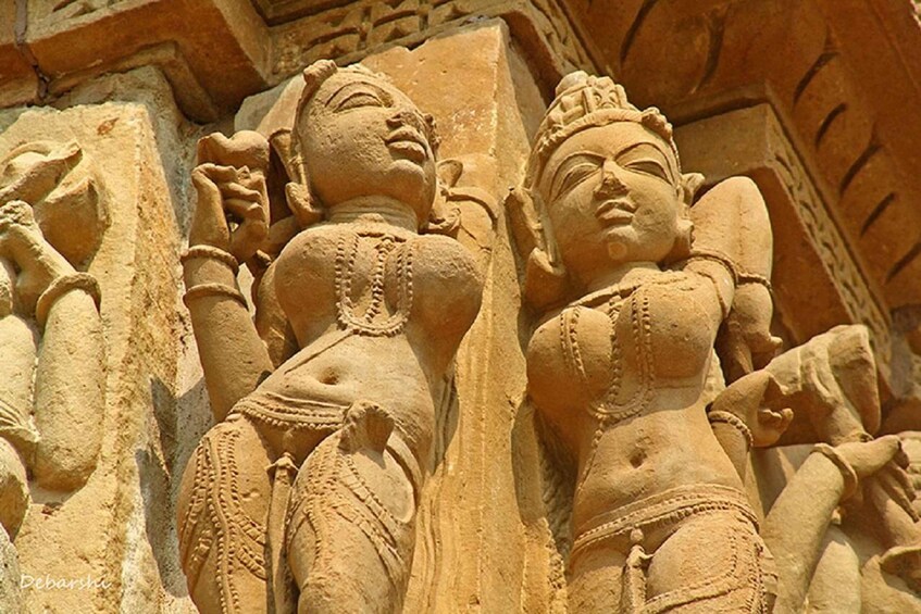 A sandstone sculpture of two figures in a temple. 4