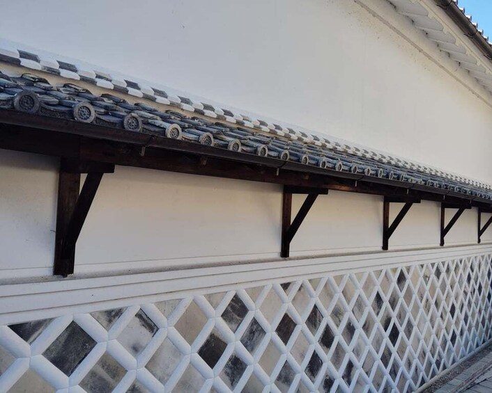 A traditional building with a tiled roof and a lattice fence. 4