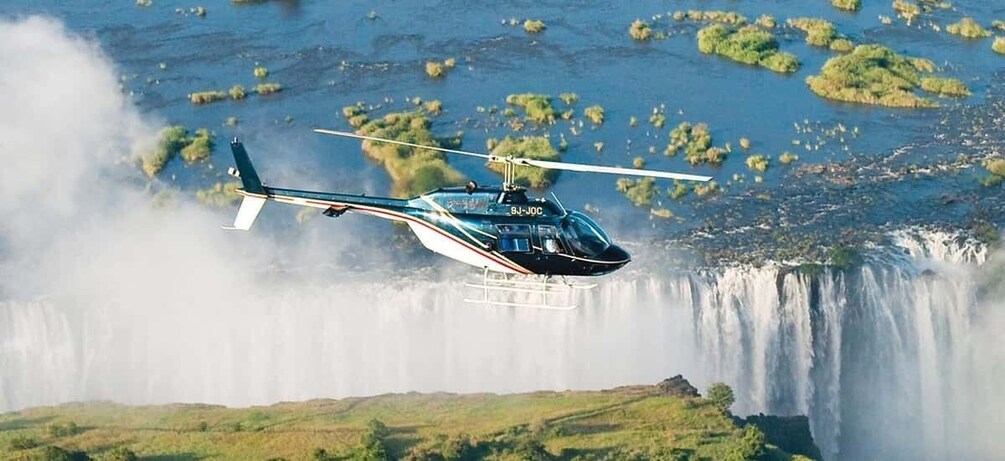 A helicopter flying over a waterfall. 1