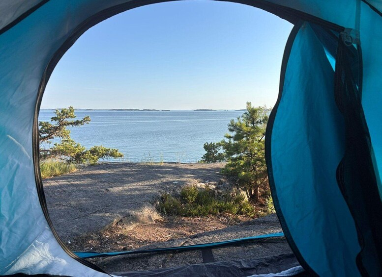 A tent with a view of a lake and trees. 1