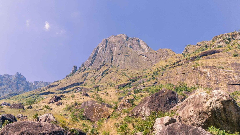 A rugged mountain landscape with rocky outcrops and sparse vegetation. 3