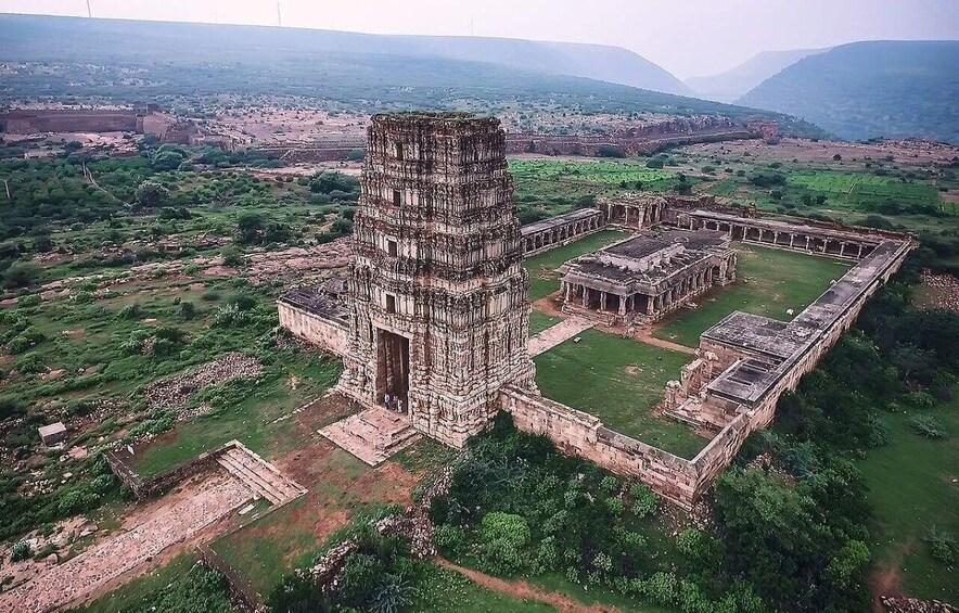 An ancient temple complex with a central tower and surrounding structures. 1
