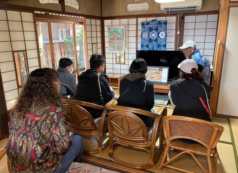 A traditional Japanese room with tatami flooring, wooden furniture, and shoji screens. 3