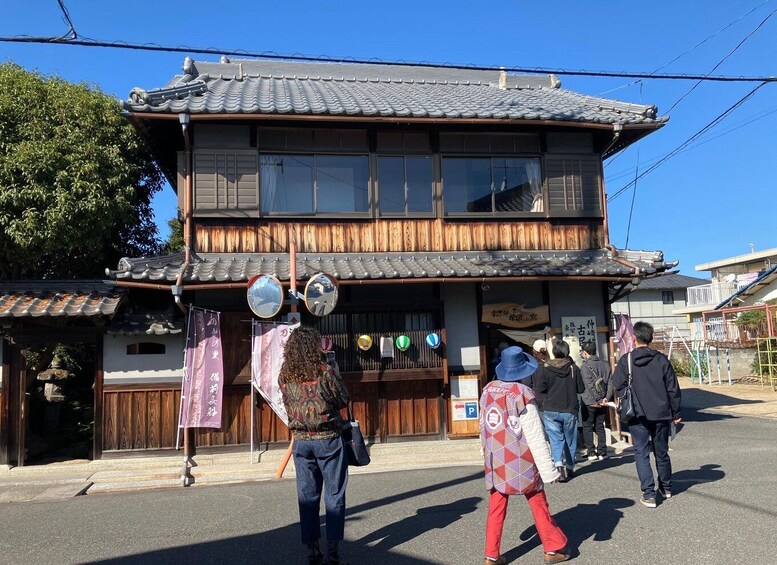 A traditional Japanese building with a tiled roof and wooden facade. 1