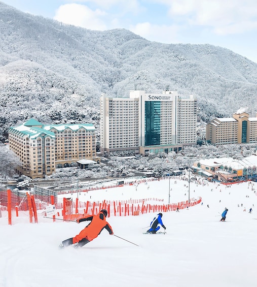 A ski resort with snow-covered slopes, a ski lift, and hotel buildings. 1