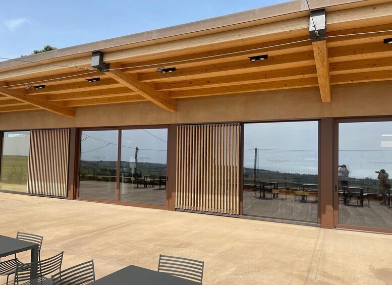 A modern building with large windows and wooden beams. 4